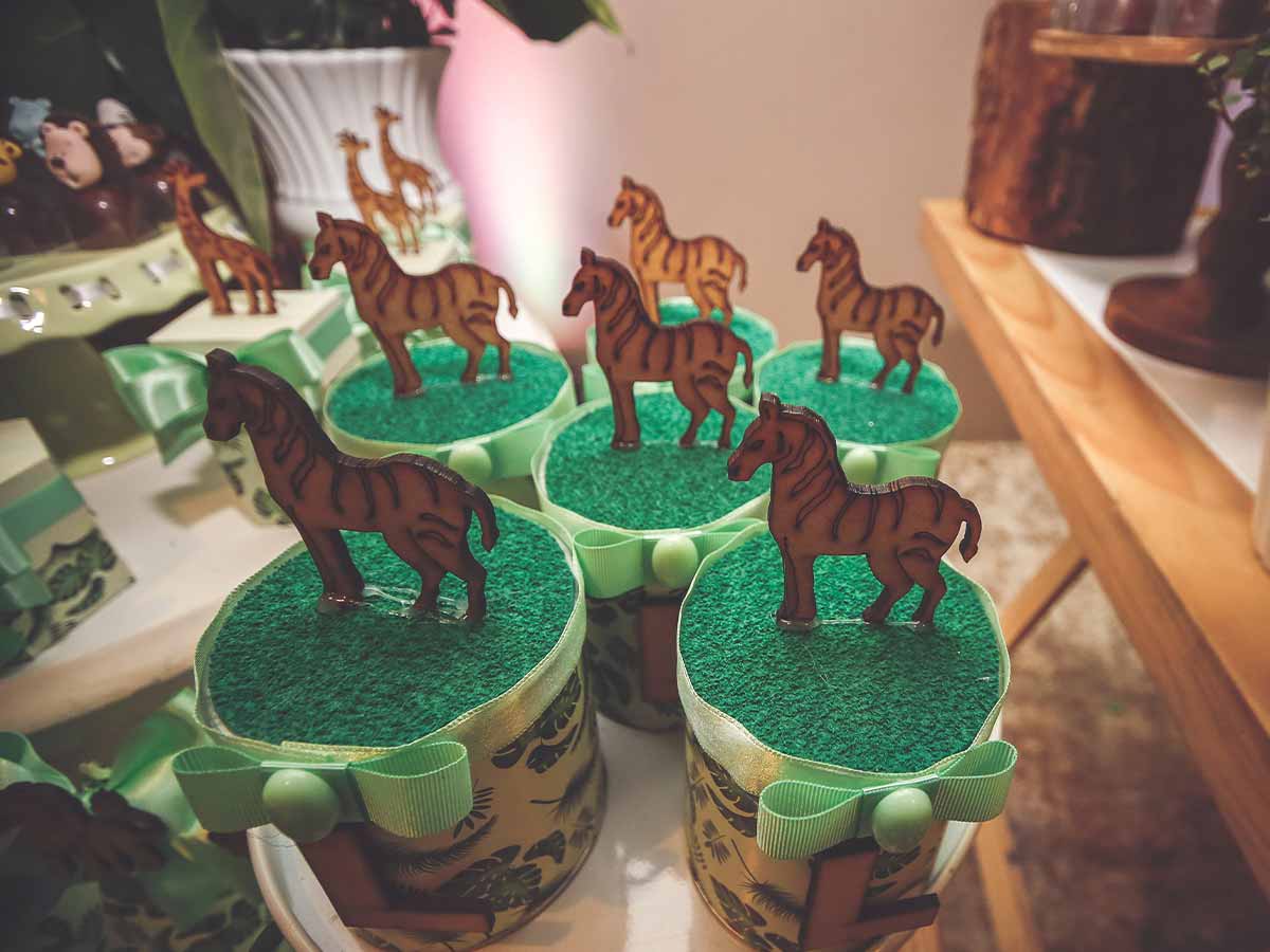 Jungle-themed cupcakes with little zebra figures on top.