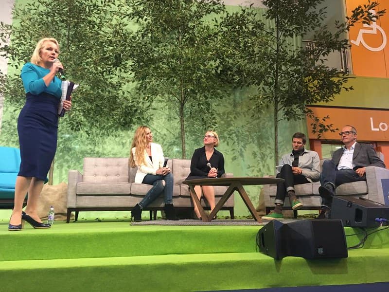 Panelists at the Grand Designs Live exhibition sitting on the stage discussing design topics.