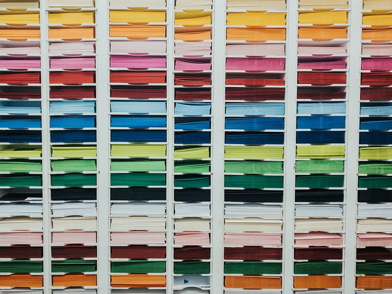 Shelves of coloured card in different sizes.