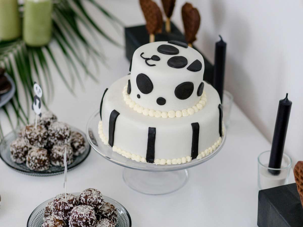 Black and white tiered cake, decorated with a panda face.