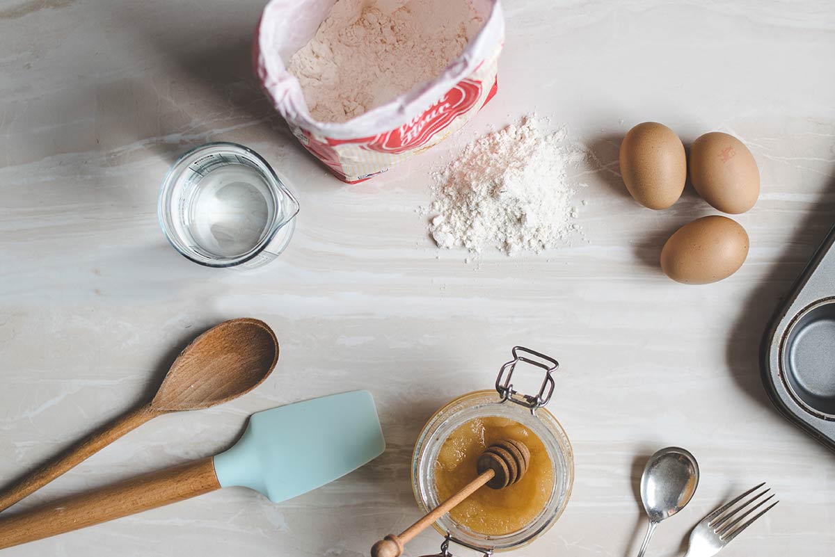 Ingredients for baking a cake laid out on the table top.