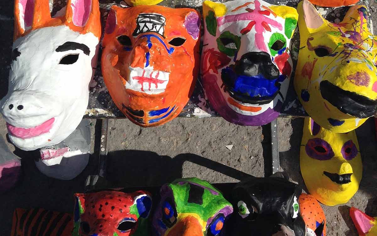 Papier mâché animal heads hanging on a wall.