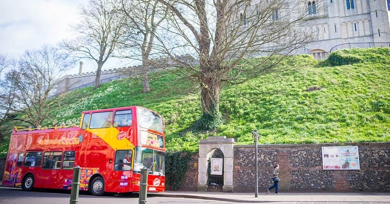 An open-top double-decker sightseeing bus at at Castle Meadow in Norwich.