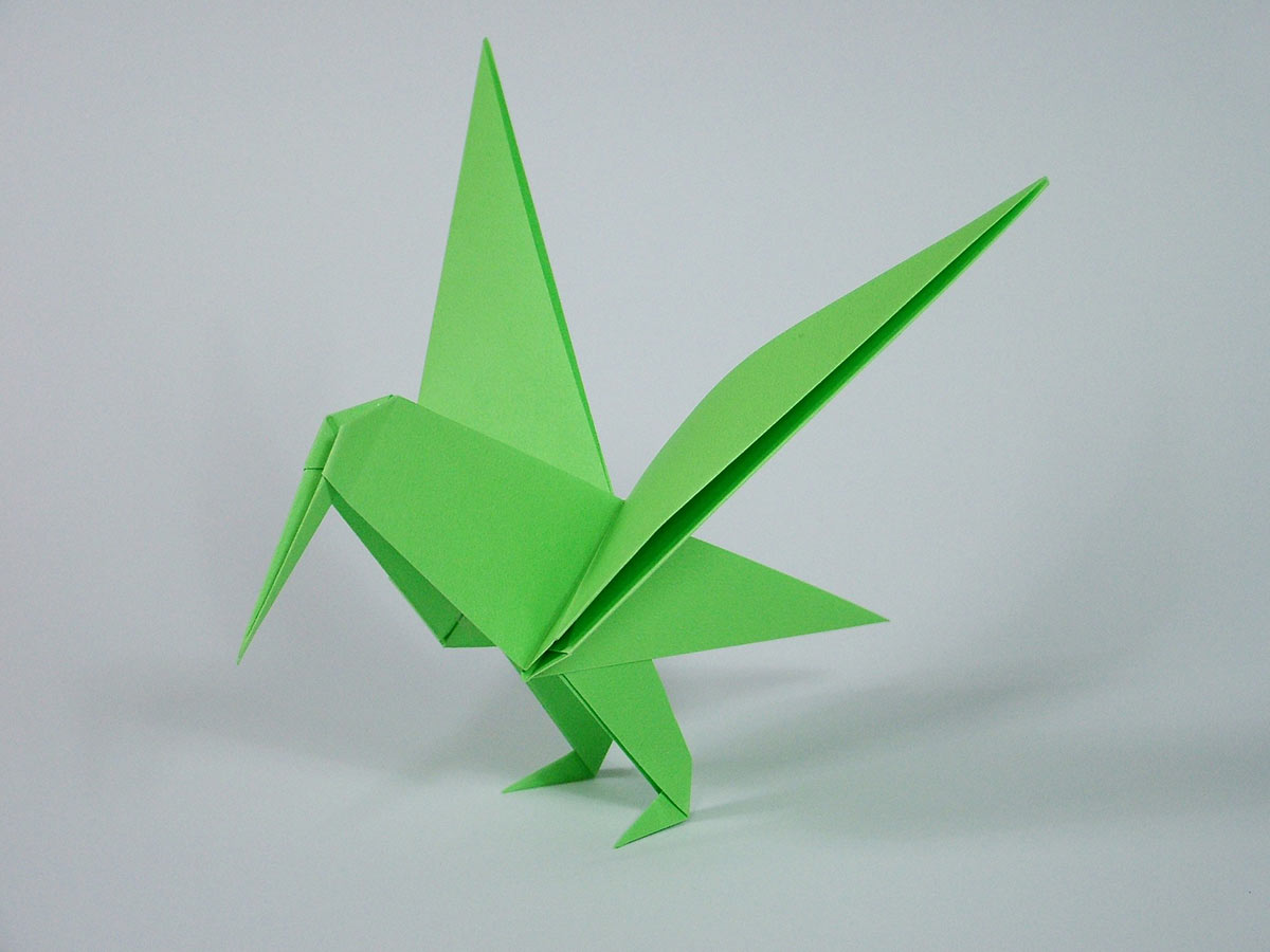 A bright green origami hummingbird.