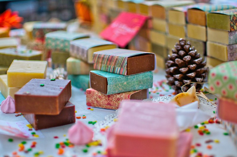Lots of colourful bars of organic soap for kids, wrapped in patterned paper.
