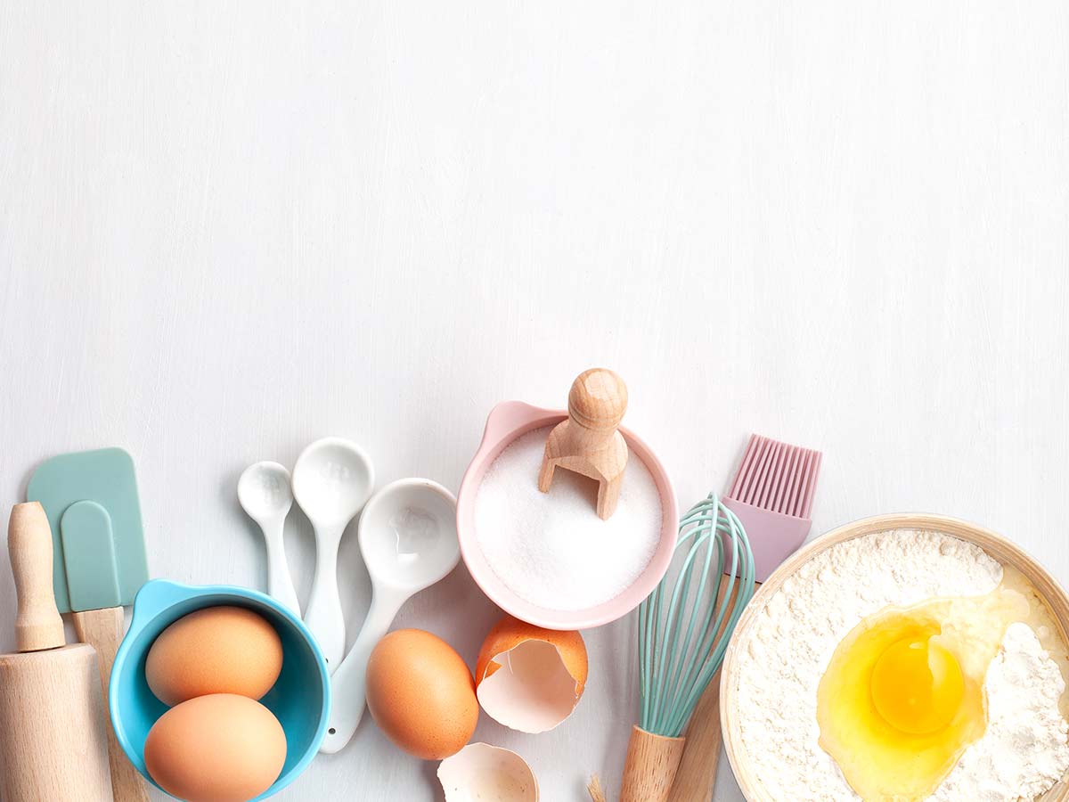 Baking ingredients and equipment on the kitchen surface.