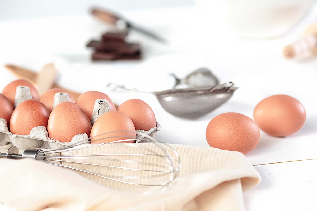 Lots of eggs and a whisk to use to make a burger cake.