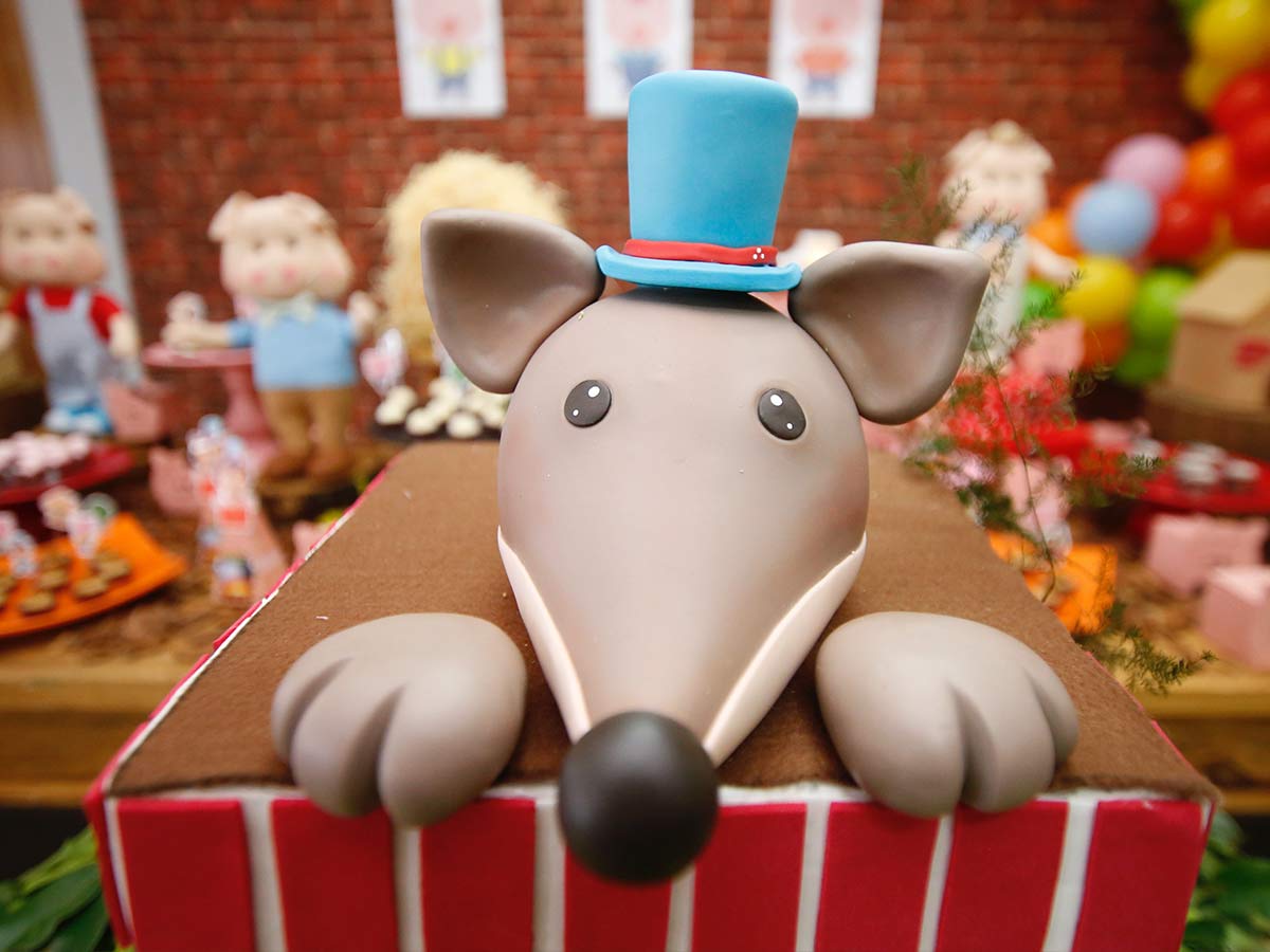 Birthday cake with a dog shaped icing on top wearing a top hat.