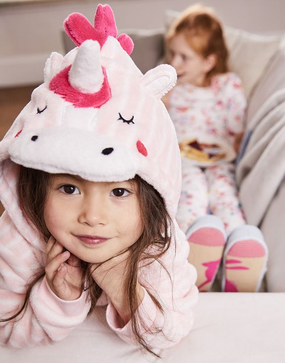 Little girl smiling wearing Fleur Novelty Character Onesie - Joules.