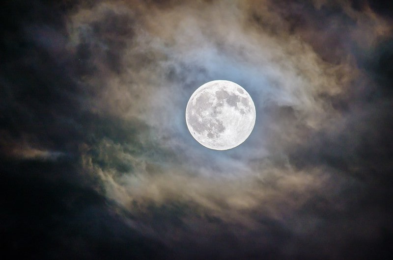 A bright full moon seemingly glowing through the clouds is one of the things you can see in the amazing night sky.
