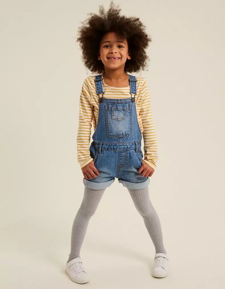 Young girl wearing FatFace Denim Shortie Dungarees.