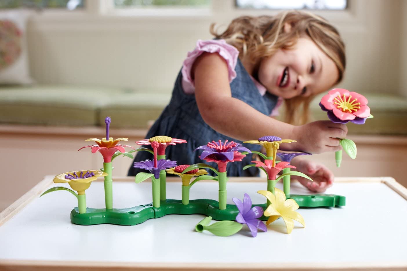 Little girl making a flower arrangement.