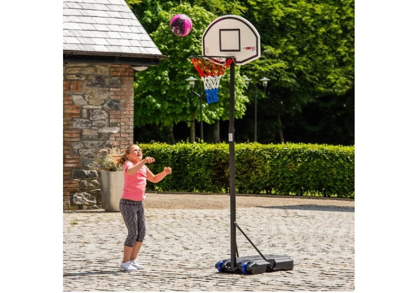 Girl playing with basketball outdoor.