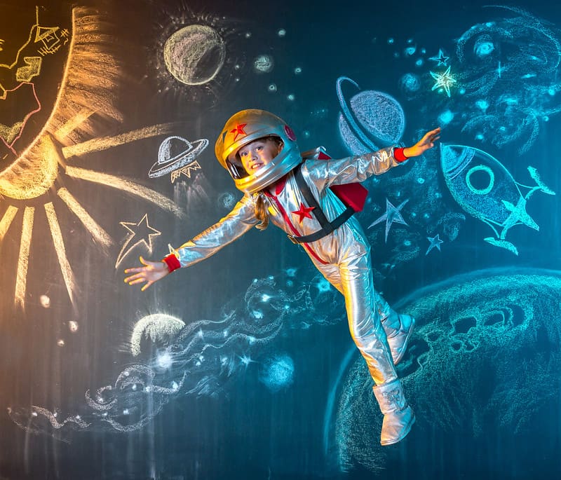 Little girl dressed as an astronaut pretending to float at zero gravity, which is a incorrect 'fact'.