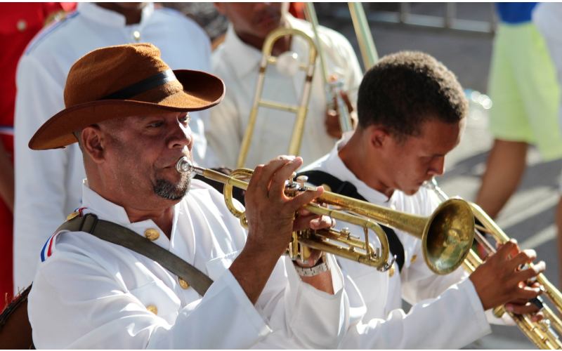 Dominican musican men playing trumpets.