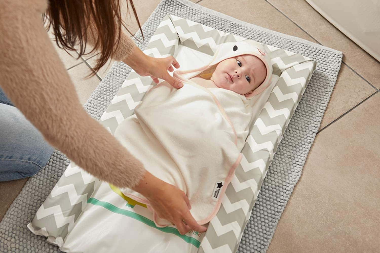 New born baby wrapped in swaddle dry towel.