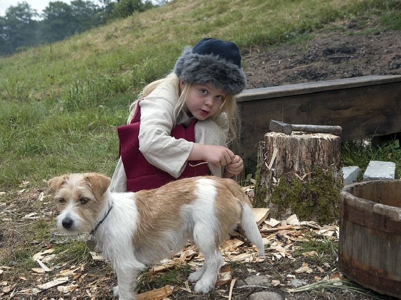 An adorable Scandinavian girl with her pet dog.