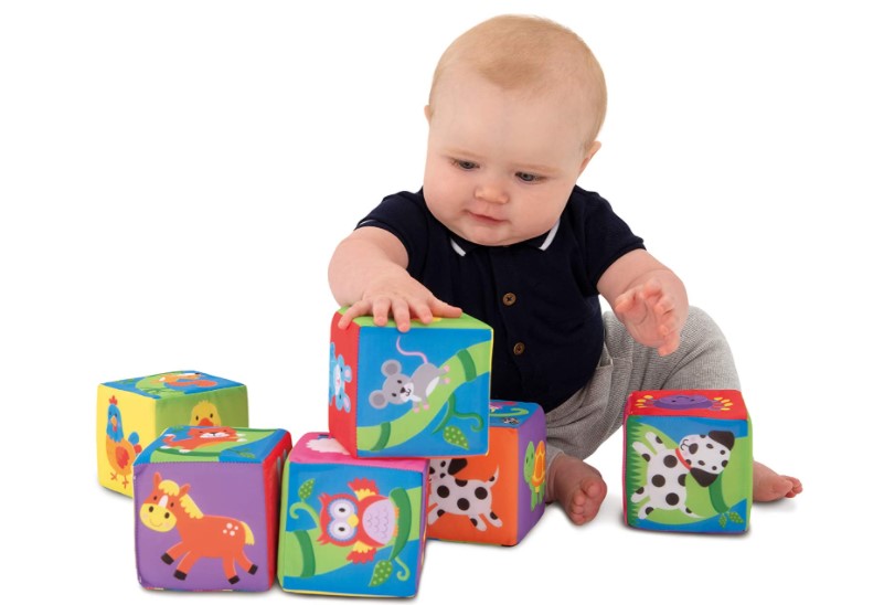Baby playing with soft, lightweight and perfect for squeezing blocks.