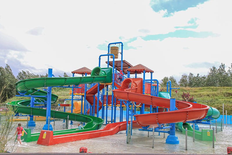 A green and a red slide at the water park at Twinlakes Theme Park.