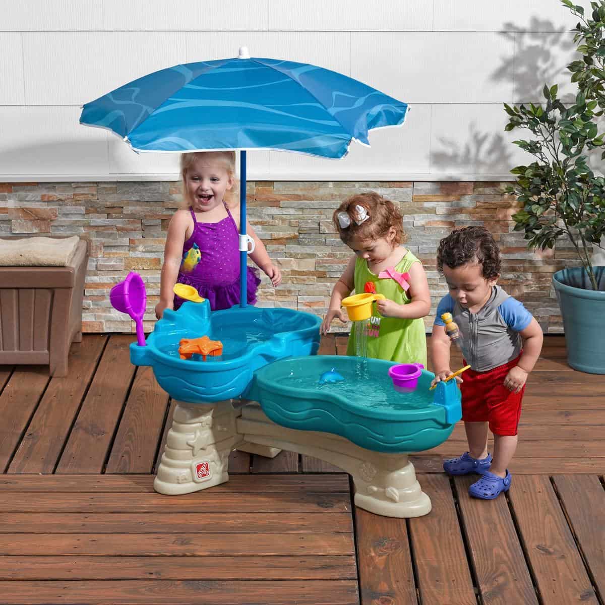 Kids playing spill and splash seaway water table.