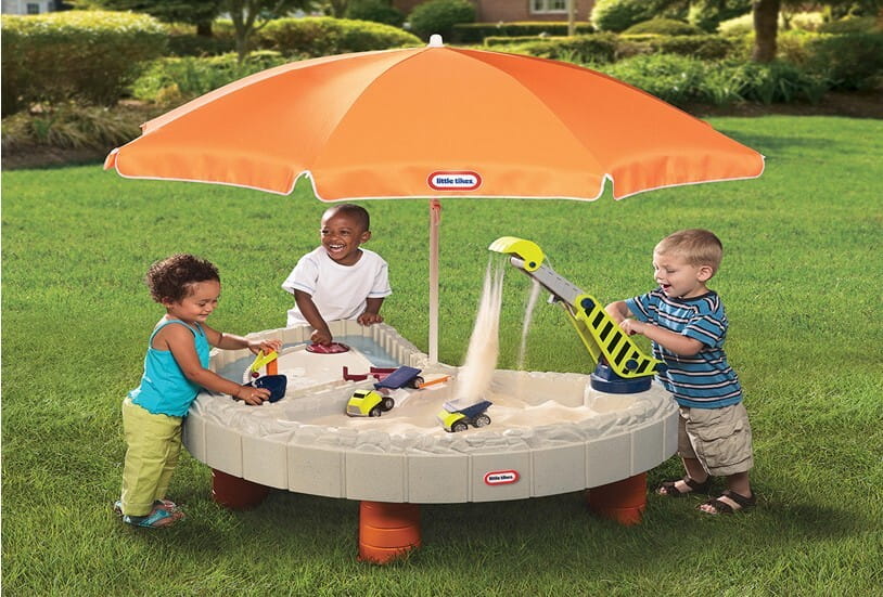 Little boys playing builders bay sand and water table.