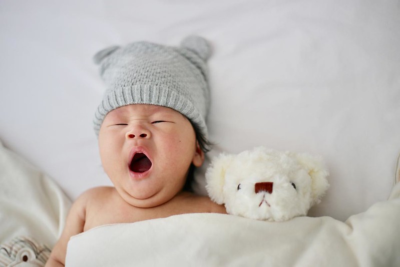 Chinky-eyed baby flashing her sleepy face.