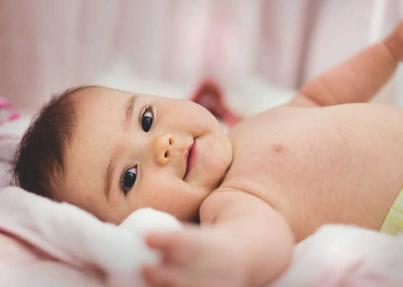 Brazilian baby stretching her right arm.