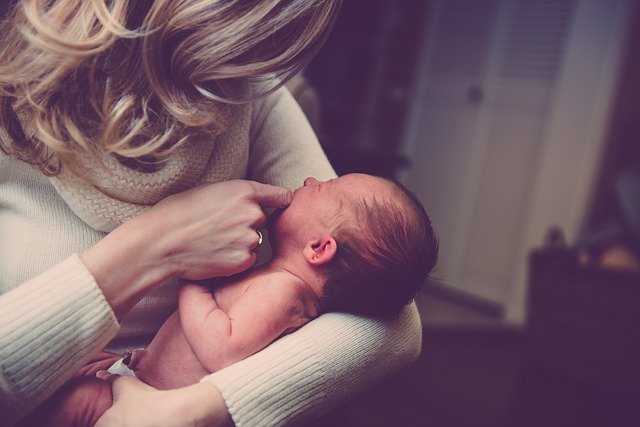 A mother holding her baby.