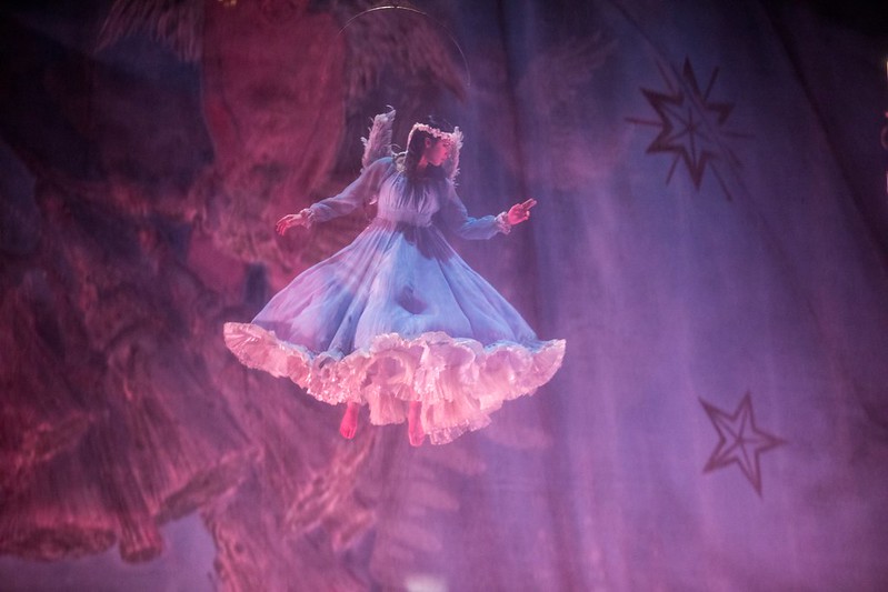 An actress in the Cirque du Soleil show dressed as an angel suspended from the ceiling.