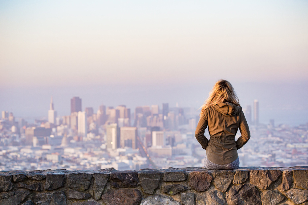 Woman looking out at city skyline.
