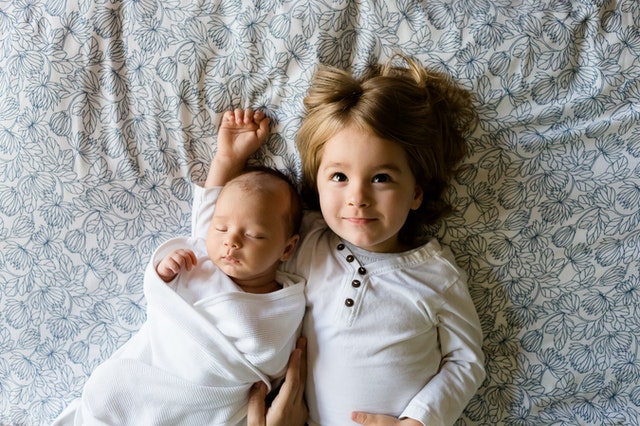 Toddlers really enjoy playing with their little siblings!