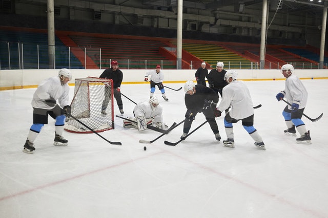 The team's goalie must prevent the puck from entering the net.