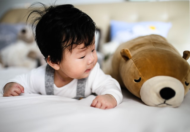 Make tummy time fun with a toy to help baby crawl.