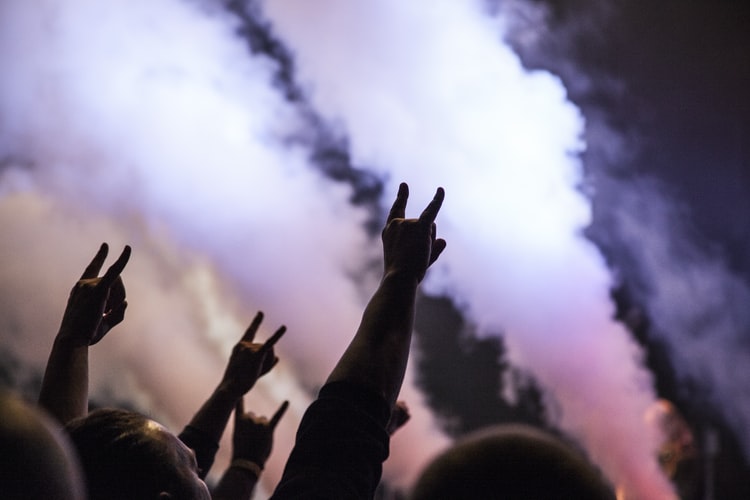 A crowd is often inspired whilst enjoying a rock concert.