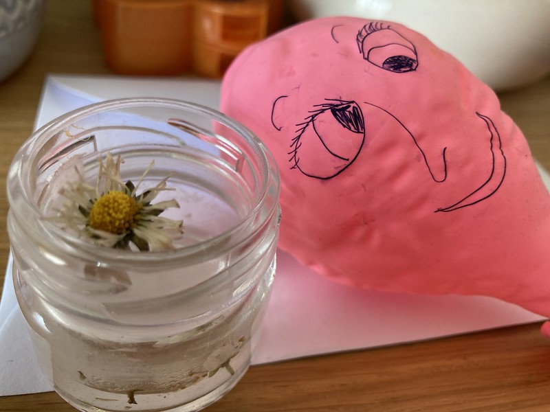 Partly deflated balloon with a smudged face.