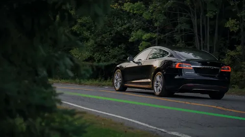 Rear view of a Tesla Model S driving