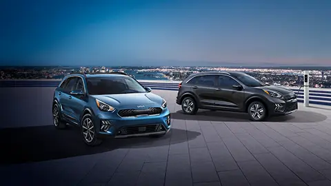 two Kia hybrid cars on a rooftop