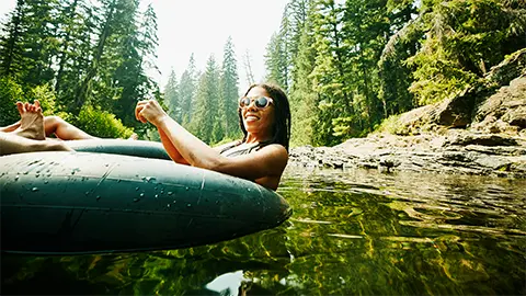 a woman floating down the river on an innter-tube