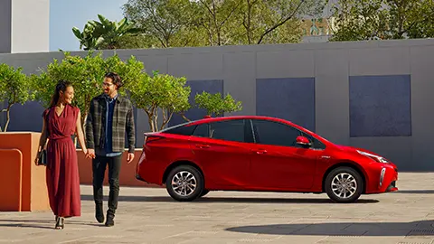 Couple walking from their parked hybrid