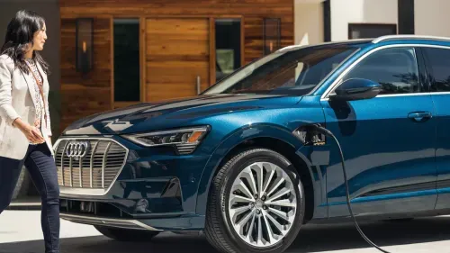Woman charging an Audi e-tron