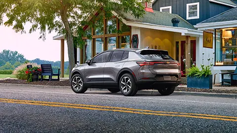 2024 Chevrolet Equinox EV parked on a street with lush and green environement