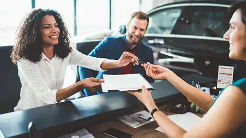 Couple in showroom buying a new car