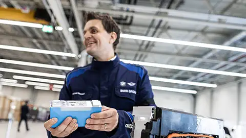 BMW employee holding battery