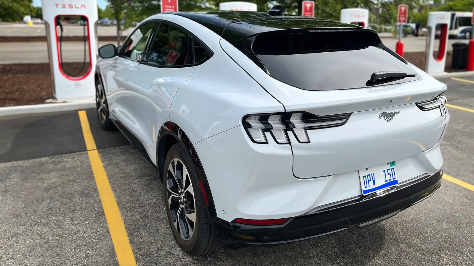 White Ford Mustang Mach-E using Tesla charging port 