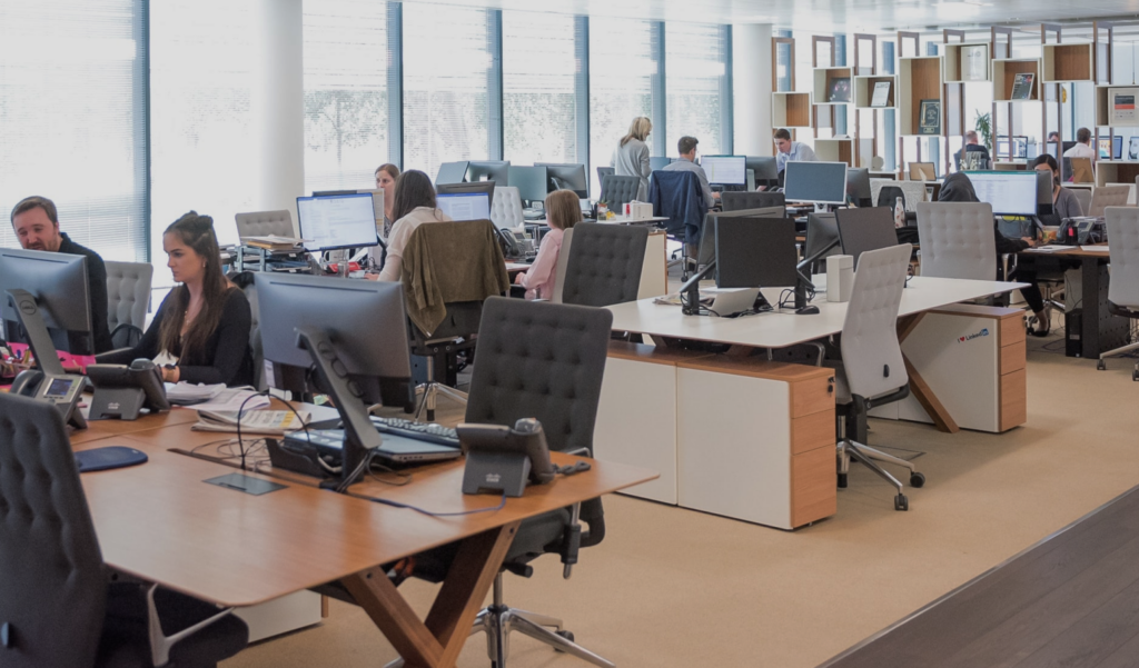 Open-plan office with uniform workstations.