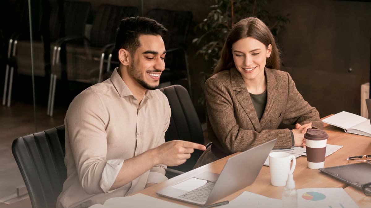 Man and woman working together on a laptop