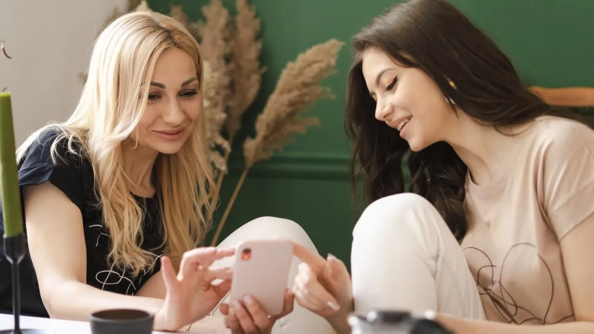 Two women looking at smartphone
