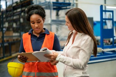 Manager showing plan to workers