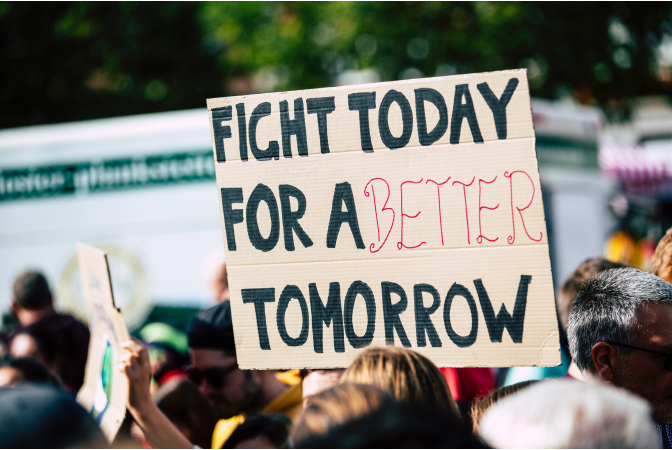 Climate change protest with sign reading "fight for a better tomorrow".