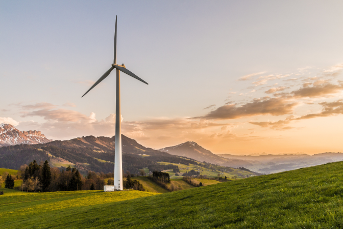 Wind turbine with a lush mountain background